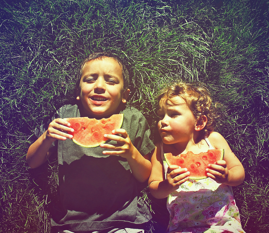   Two children eating watermelon  photo from  graphicphoto  