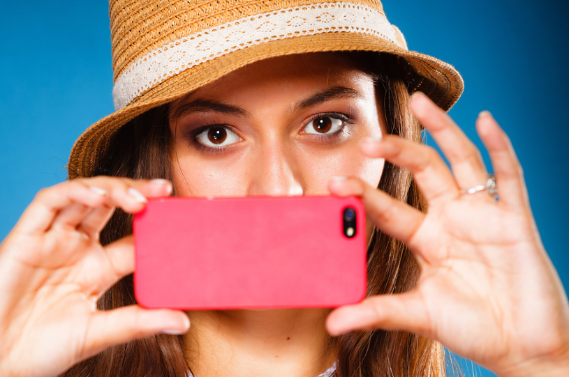  Stock photo of woman with pink smartphone. 