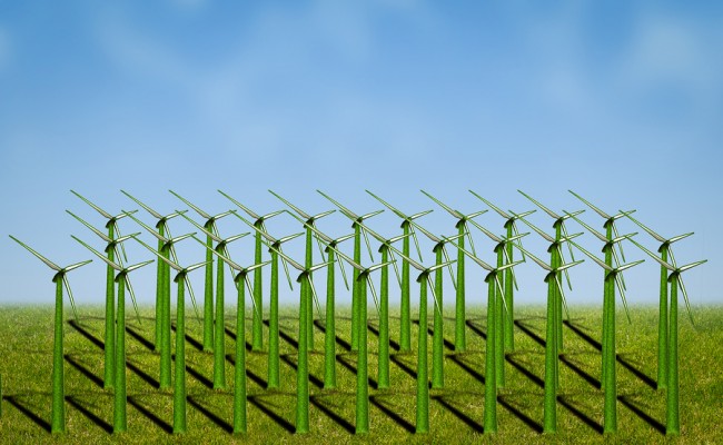  photo of wind turbines covered with grass in a field 
