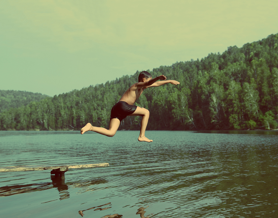   Boy jumping in lake  photo from  Kokhanchikov  