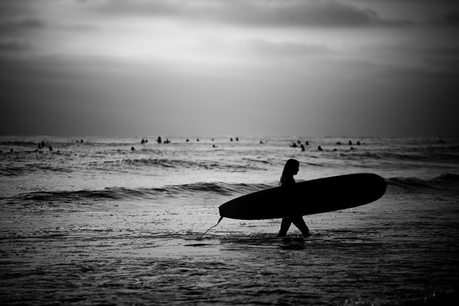   Female Surfer On Beach Image ©Simeon Rodgers  